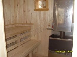 Парилка с печкой "Русь" от фирмы "Теплодар" и полком из осинового бруска в бане из бруса